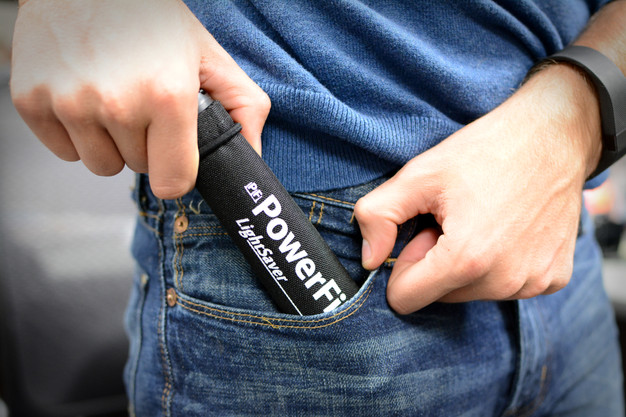 LightSaver Portable Solar Charger being put into a pant's pocket