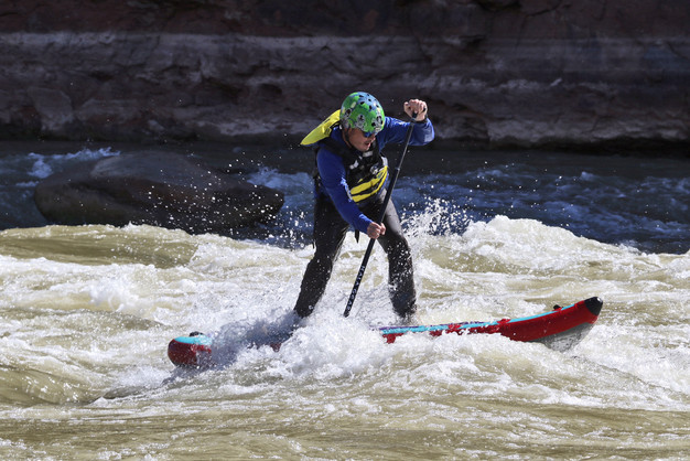 Clinton Johnson paddleboarding on rough waters