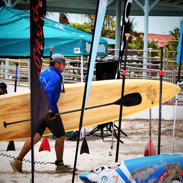 Clinton Johnson carrying a paddleboard