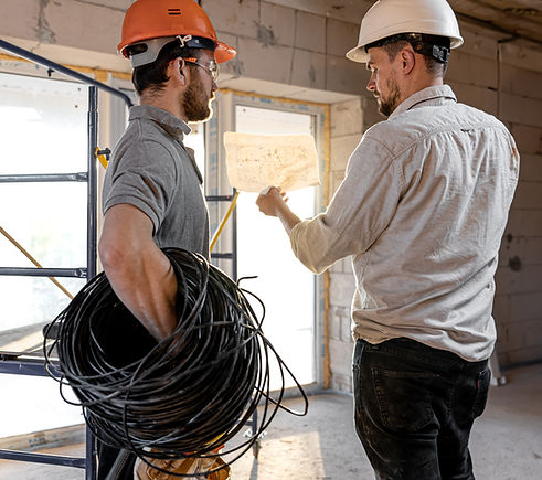 two-builder-engineers-talking-building-site-engineer-explaining-drawing-worker.jpg