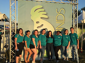 SOJ volunteer group at front gate scrim