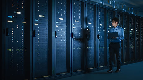 In Dark Data Center_ Male IT Specialist Walks along the Row of Operational Server Racks, U