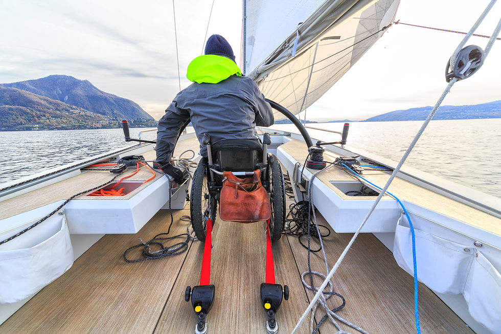 Man in a wheelchair sailing a boat