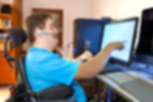 man in wheelchair using computer