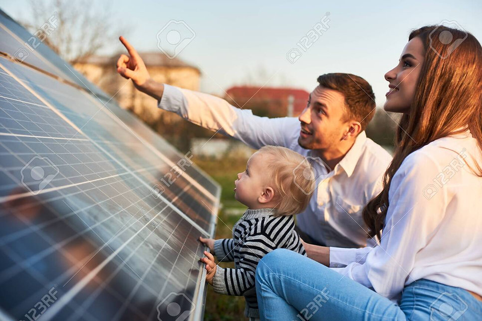 142382317-man-shows-his-family-the-solar-panels-on-the-plot-near-the-house-during-a-warm-d