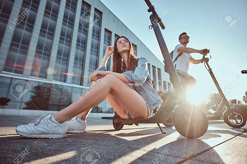 125228501-on-a-bright-sunshining-day-couple-of-young-people-chilling-near-big-building-wit