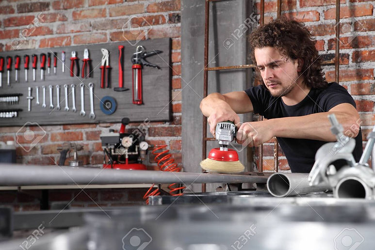133162991-man-in-home-workshop-garage-work-metal-with-wire-brush-angle-grinder-machine-rep