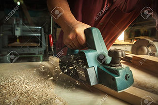 43152478-carpenter-working-with-electric-planer-on-wooden-plank-in-workshop-.jpeg