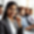 Smiling woman in a call center wearing a headset, sitting with colleagues in background. Bright, professional setting evokes positivity. Customer Care Executive of ATLANTA GROUP happy to serve customer 24/7