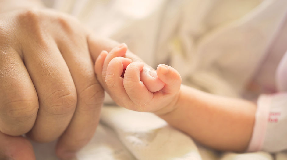 Baby Holding Parent