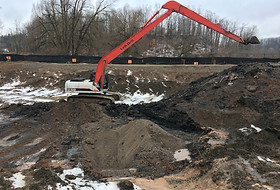 excavator carrying out environmental clean-up and removal of contaminated soils