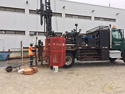 Truck-mounted drill-rig on project site