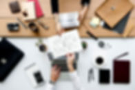 aerial-colleagues-hands-sharing-work-she