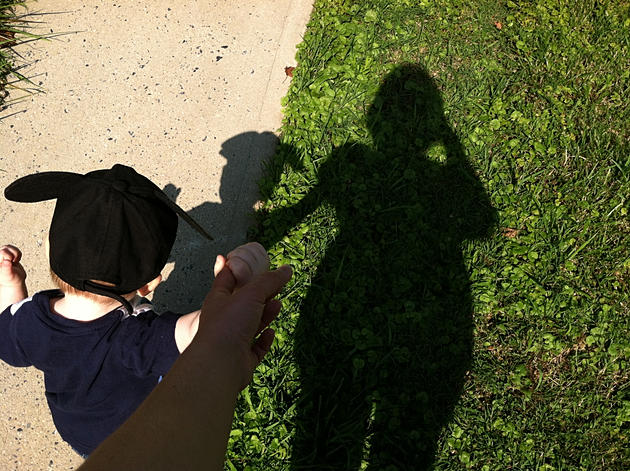 My son and I walking, our shadows in front of us.