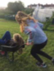 Children playing with wheel barrow