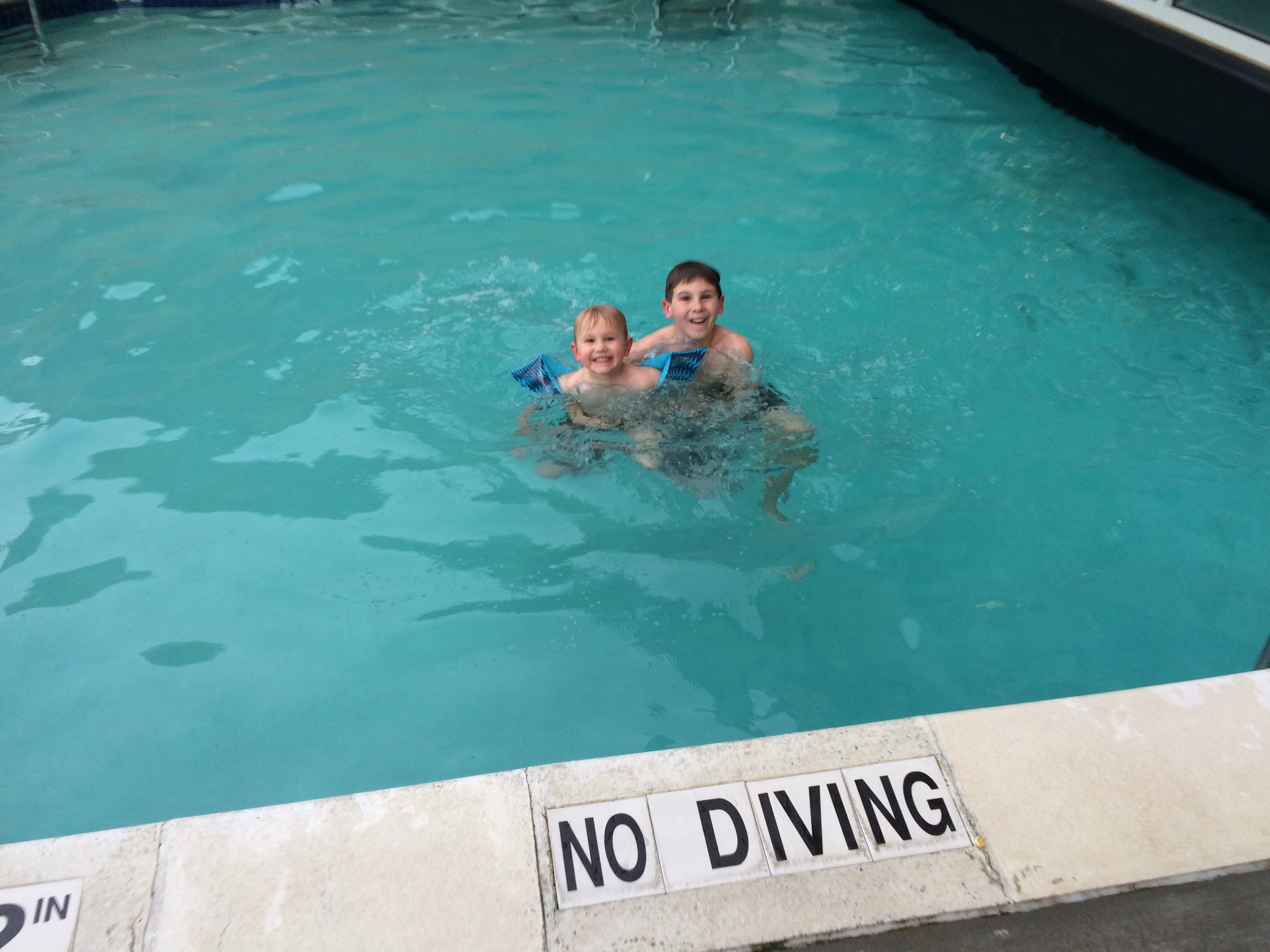 2 boys in hotel swimming pool