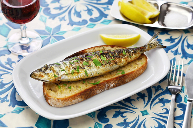 Traditional Portuguese food sardines on bread red wine