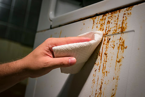 Hand cleaning baked on kitchen grime on