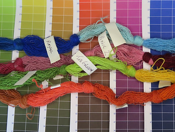 Scotweave Yarn Designer colour pages with coloured yarns lying on top.