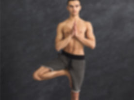 young-man-training-yoga-in-tree-pose-pic