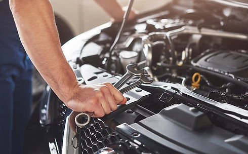 muscular-car-service-worker-repairing-vehicle_146671-19605.jpg