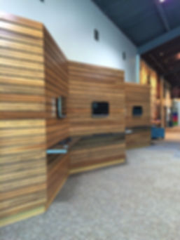 Element Church renovated concourse with undulating wood plank feature wall and check-in stations. DE|SL LLC