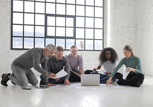group-of-people-sitting-on-the-floor-whi