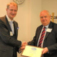 Iain Miskimmin presents Phil Jackson with COMIT Fellowship