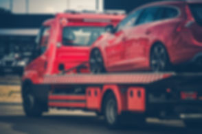 Red Broken Car on a Red Towing Truck. Cl