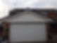 White exterior cladding installed on garage and house façade