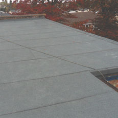 Close-up of flat roofing surface with smooth waterproof membrane finish