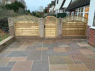 Paved patio area with wooden fencing in modern garden