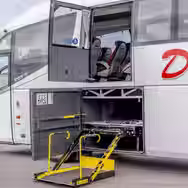 Coach luggage compartment with accessibility lift and storage space