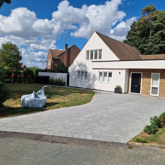 A modern, two-story house with white walls and a sloped roof