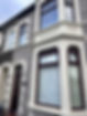 Exterior view of traditional terraced house with clean white windows