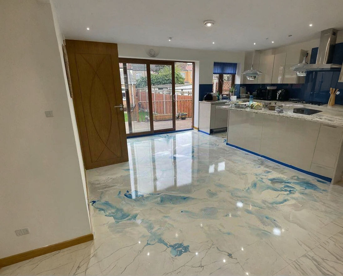 Modern kitchen interior with glossy blue and white marble effect resin floor