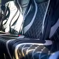 Comfortable leather coach seats with spacious legroom and interior