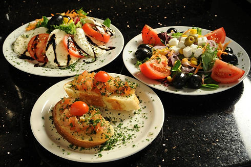 Italian bruschetta and mixed antipasti starter plates