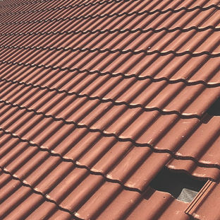 Neatly installed red clay roof tiles on residential property