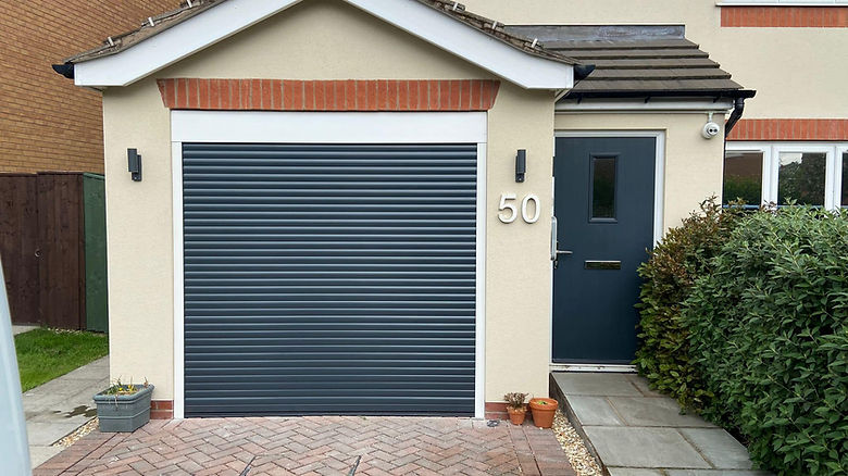Anthracite grey electric roller garage door fitted to modern home