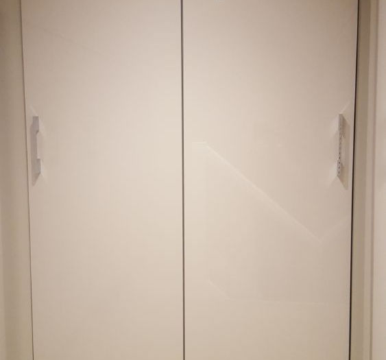 wardrobe with sleek handles, set against a light wall