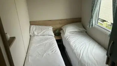 bedroom with two beds another photo