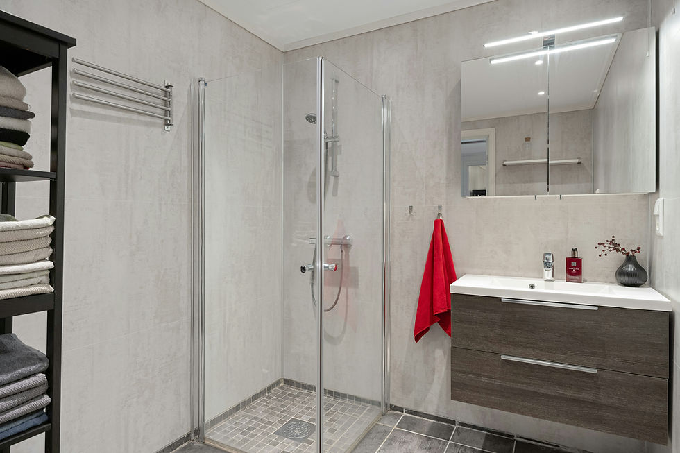A bathroom with a stand up shower next to a sink_edited.jpg