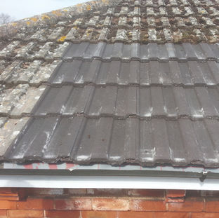 Worn tiled roof showing ageing and weather damage on surface