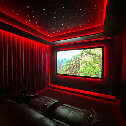 Luxurious home theater with red lighting and starry ceiling
