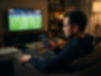 World Cup stock market effect: a man on his sofa watches a televised football match while checking red and green price candles on a stock-trading app on his ph…World Cup stock market effect: a man on his sofa watches a televised football match while checking red and green price candles on a stock-trading app on his phone