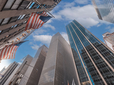 Financial district towers and US flags symbolising semi-liquid private credit funds in Wall Street markets