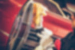 A collector in gloves carefully polishes the chrome tail light of a red classic car, illustrating the hands-on pleasure that makes collectible investments like vintage cars emotional as well as financial assets