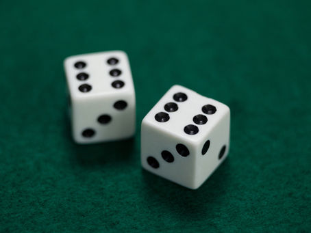 Dice on green felt table representing why mutual funds underperform: research shows most fund manager performance is luck, not skill