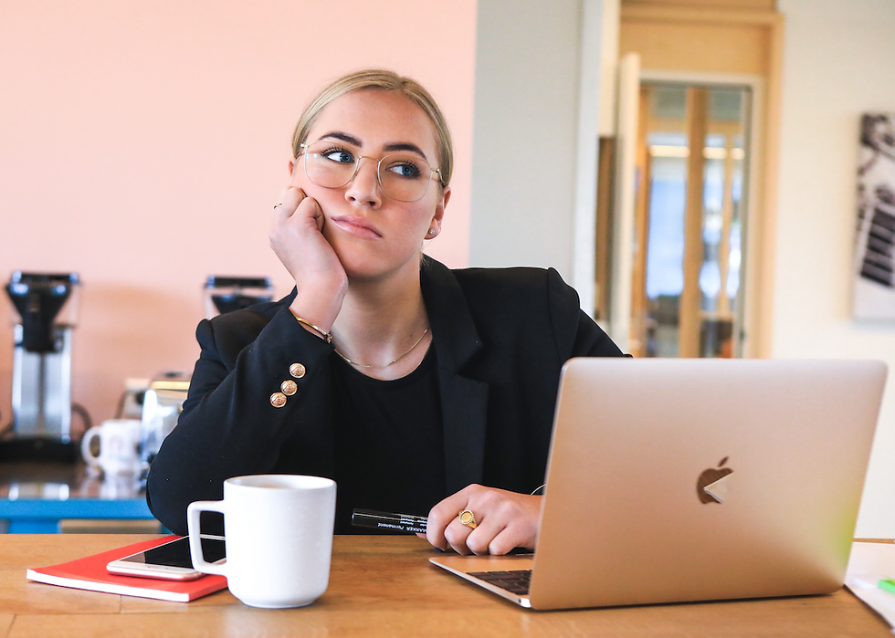 Disappointed woman looks at her laptop